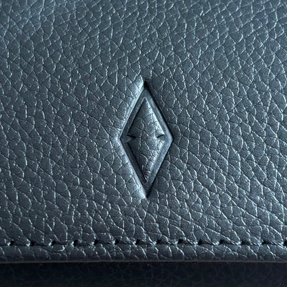 Close up of ASCATI top grain leather showing the debossed logo and natural leather grain