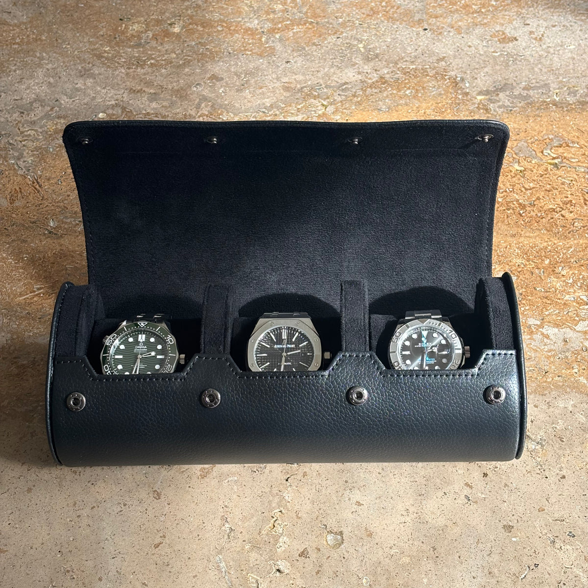 Inside the ASCATI watch roll showing three watches against the soft suede interior